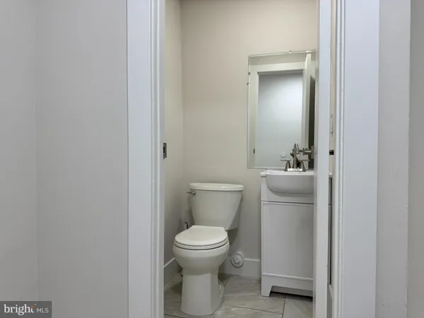 a white toilet sitting next to a bathroom sink