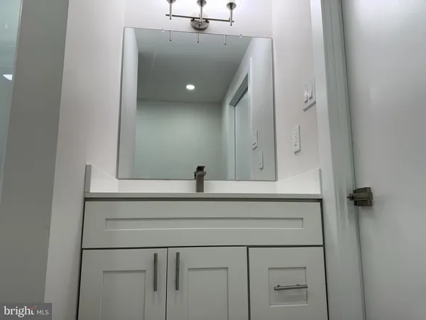 a bathroom with a sink and mirror