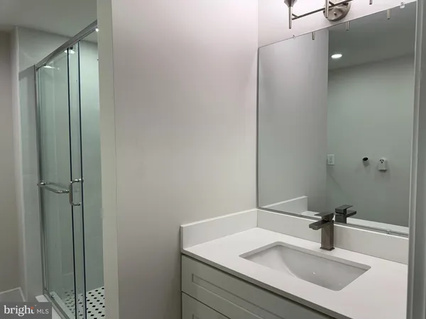 a bathroom with a sink and mirror