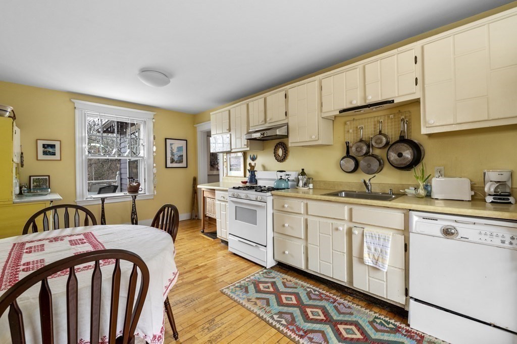 10 High Rock Way Boston, MA 02135 - Photo 11 of 26 a kitchen with stainless steel appliances granite countertop a sink and cabinets