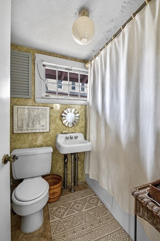 10 High Rock Way Boston, MA 02135 - Photo 12 of 26 a bathroom with a sink a toilet and bathtub