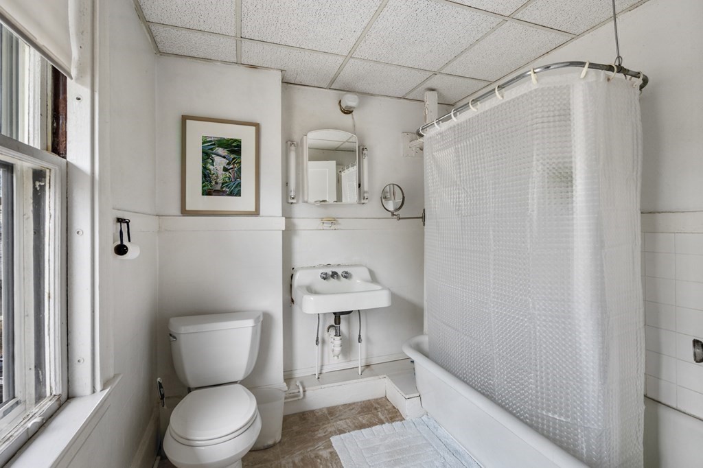 10 High Rock Way Boston, MA 02135 - Photo 16 of 26 a white toilet sitting next to a bathroom sink