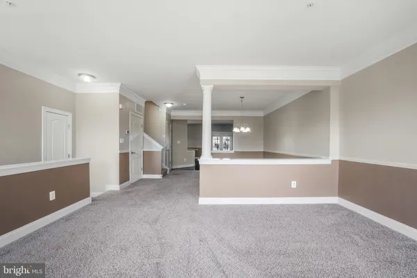 a view of a livingroom with an empty space and a window