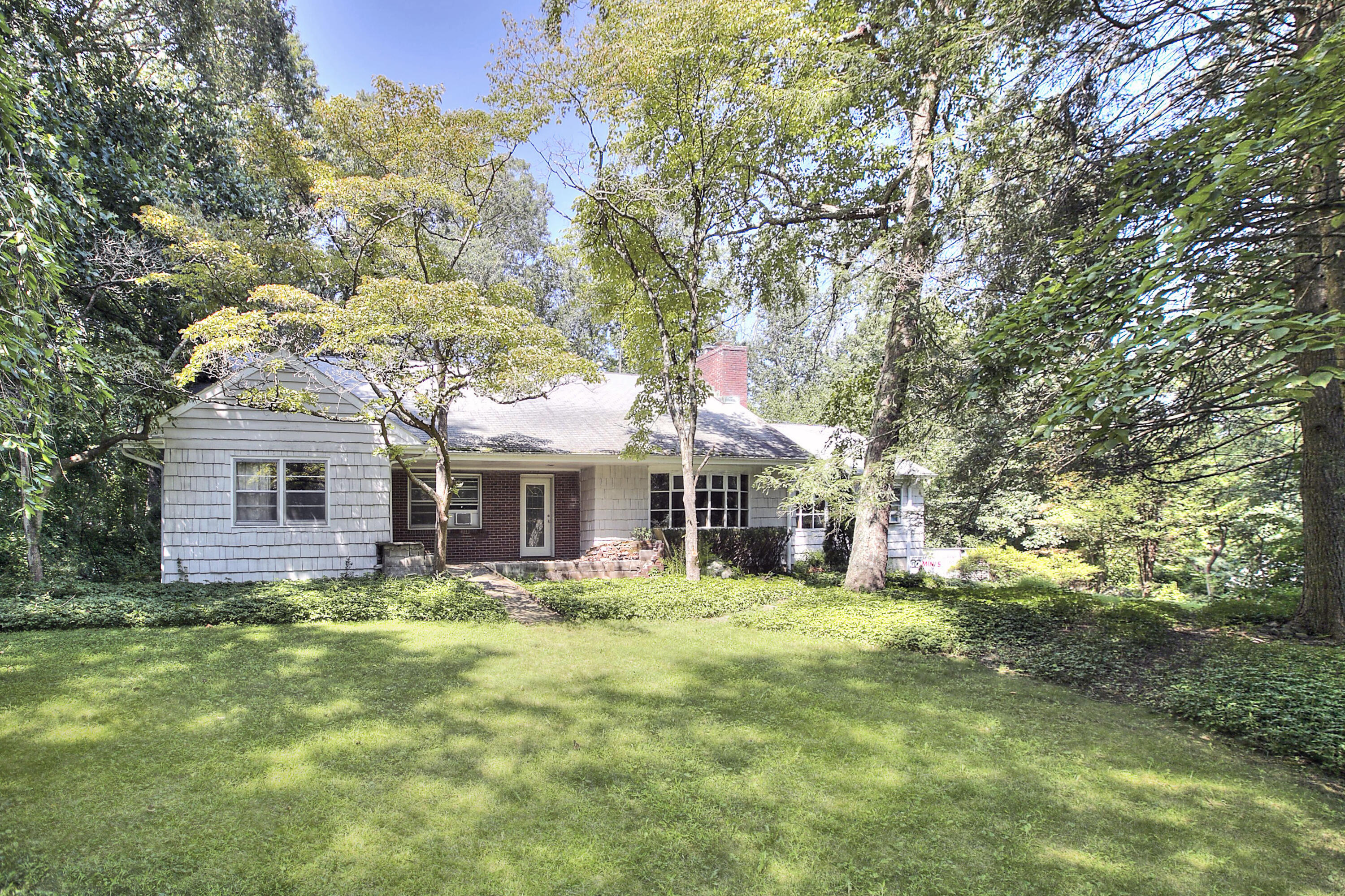 a front view of house with yard and green space