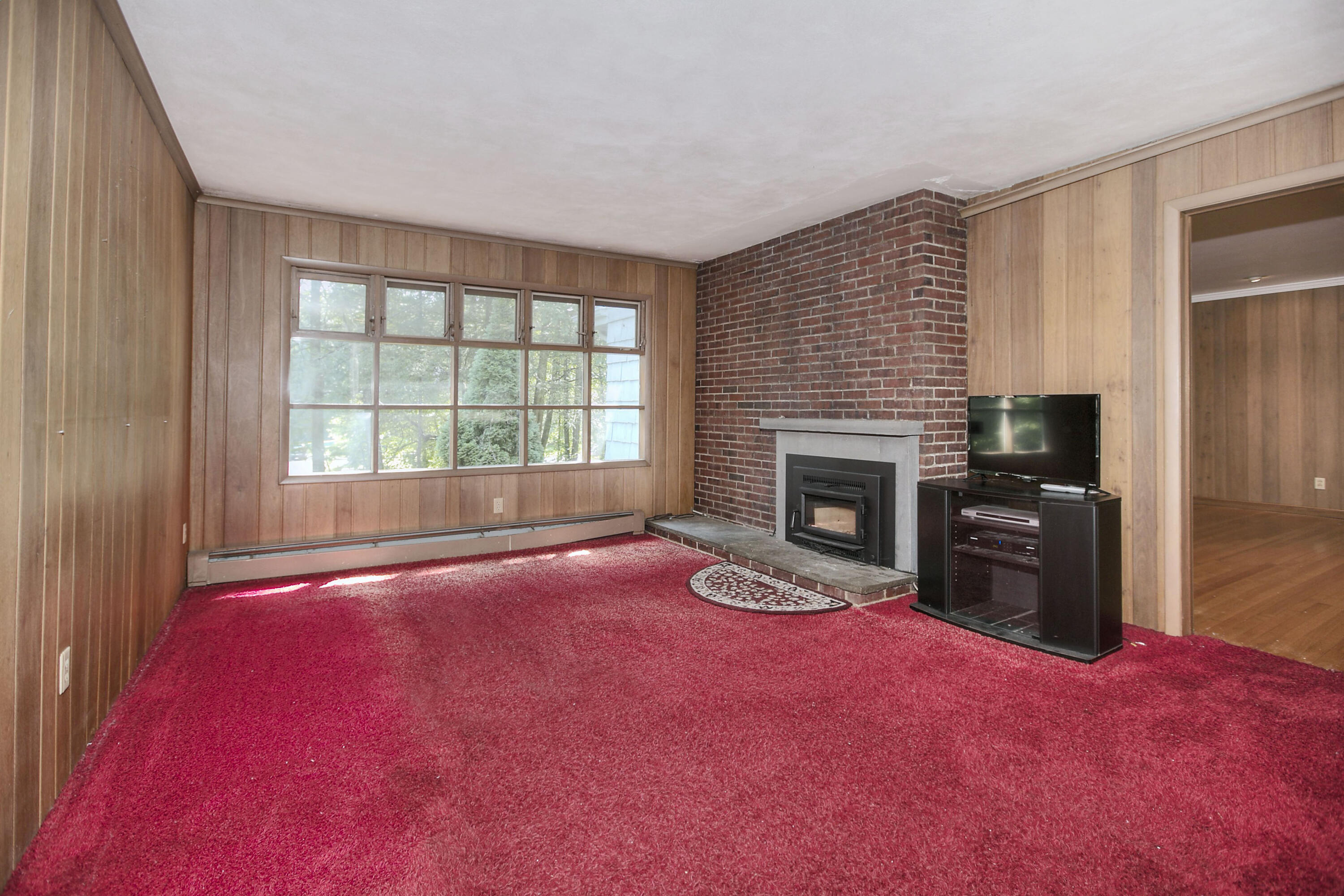 25 Hillcrest Road New Canaan, CT 06840 - Photo 11 of 19 a view of empty room with a fireplace and windows