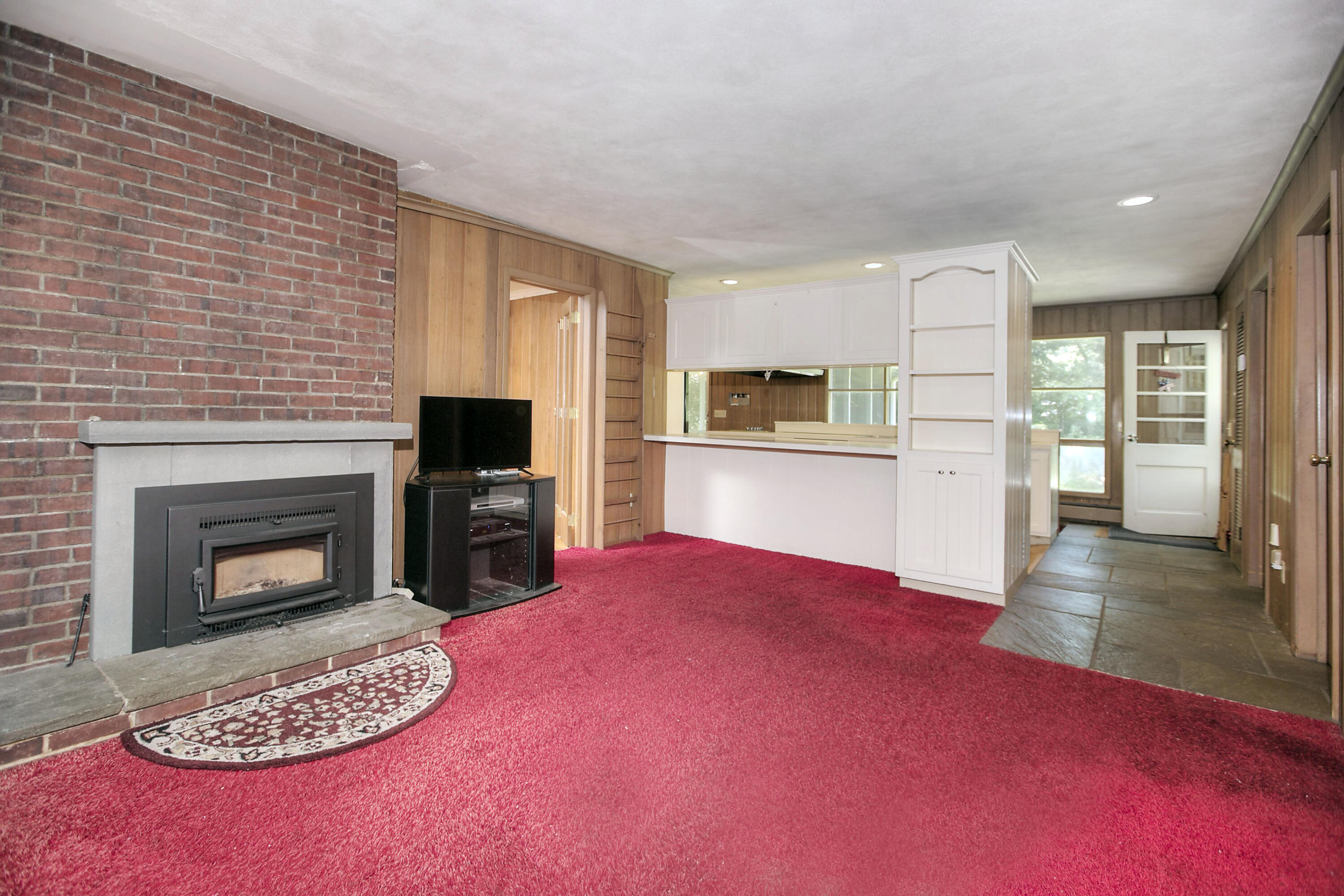 25 Hillcrest Road New Canaan, CT 06840 - Photo 12 of 19 a view of a livingroom with a fireplace a sink and a kitchen