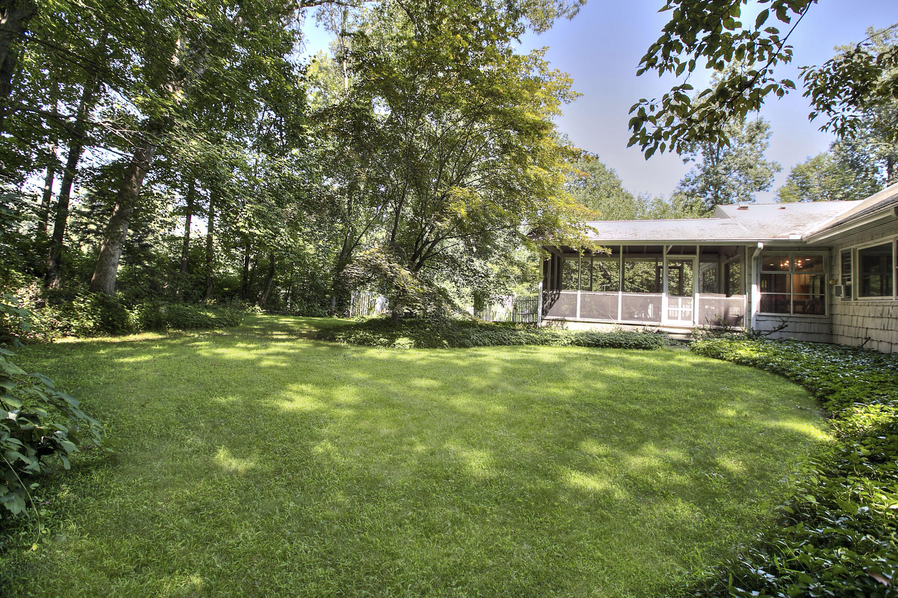 25 Hillcrest Road New Canaan, CT 06840 - Photo 18 of 19 a view of a house with a big yard and large trees