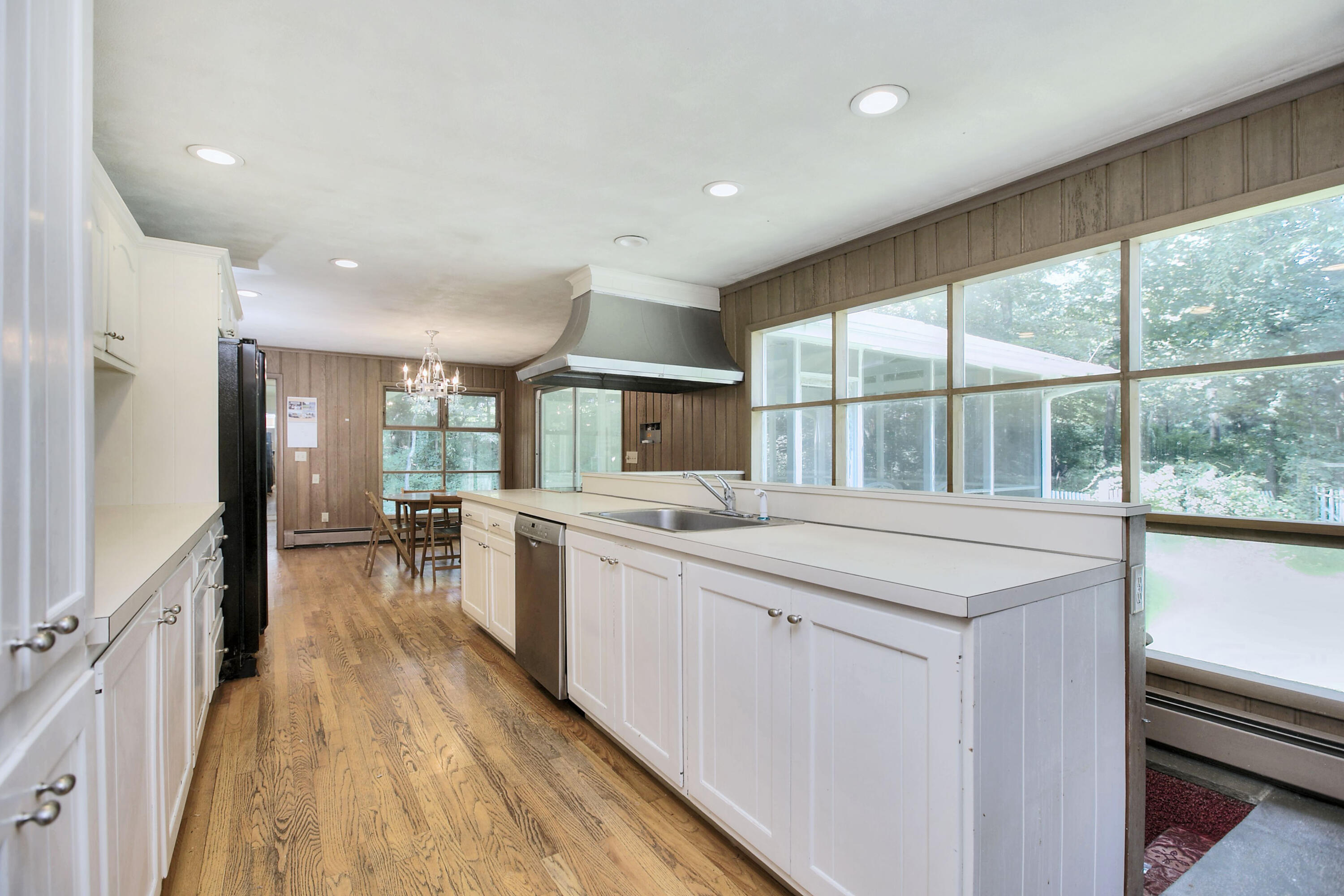25 Hillcrest Road New Canaan, CT 06840 - Photo 3 of 19 a large kitchen with kitchen island a large window a sink and stainless steel appliances