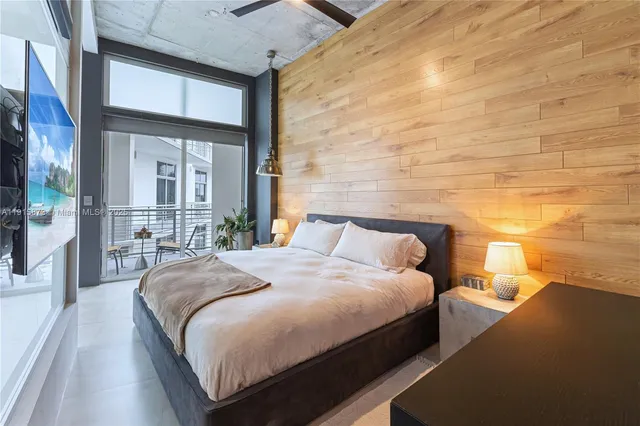 a bedroom with a large bed and a large window