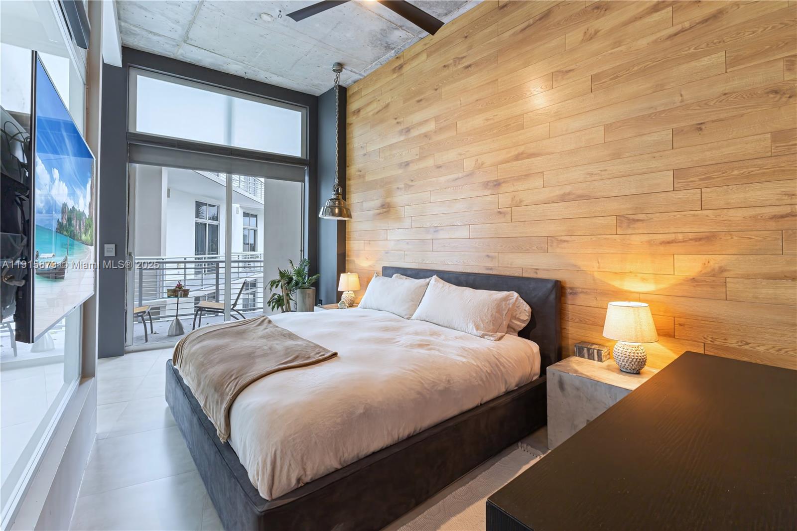 2001 Meridian Avenue, Unit 515 Miami Beach, FL 33139 - Photo 13 of 26 a bedroom with a large bed and a large window