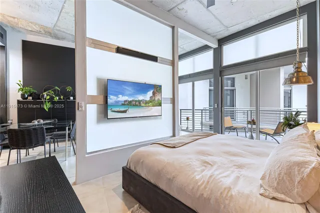 a bed sitting in a bedroom next to a window