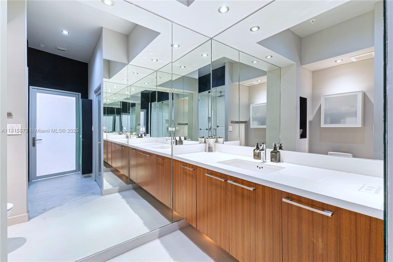 2001 Meridian Avenue, Unit 515 Miami Beach, FL 33139 - Photo 15 of 26 a large bathroom with a large mirror vanity and a sink