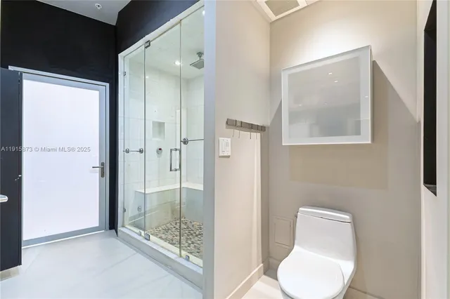 a bathroom with a toilet sink and shower