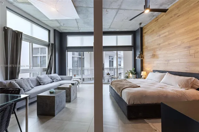 a living room with furniture and large windows