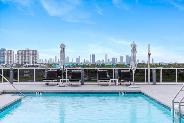 a view of a swimming pool with outdoor seating