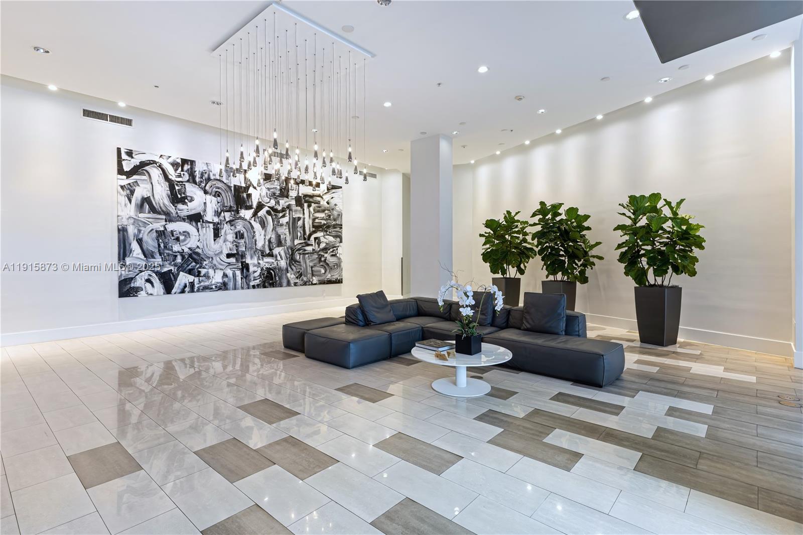 2001 Meridian Avenue, Unit 515 Miami Beach, FL 33139 - Photo 24 of 26 a living room with furniture flowers and a potted plant