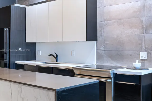 a kitchen with a sink and cabinets