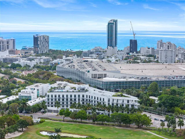 a view of a city with tall buildings and a big yard