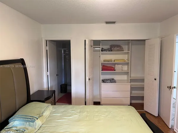 a bedroom with a bed and a closet