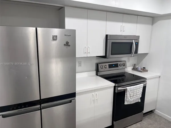 a kitchen with a refrigerator stove and microwave