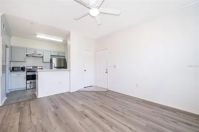a view of kitchen with wooden floor and electronic appliances