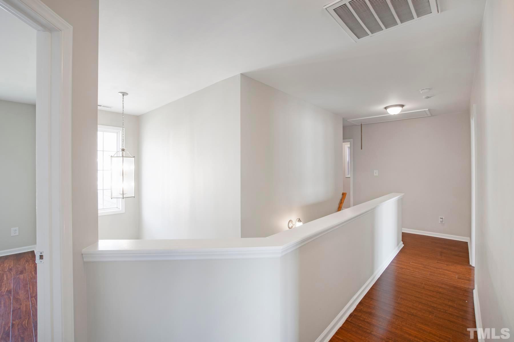 7814 Braefield Drive Raleigh, NC 27616 - Photo 11 of 29 a view of an empty room with wooden floor and a window
