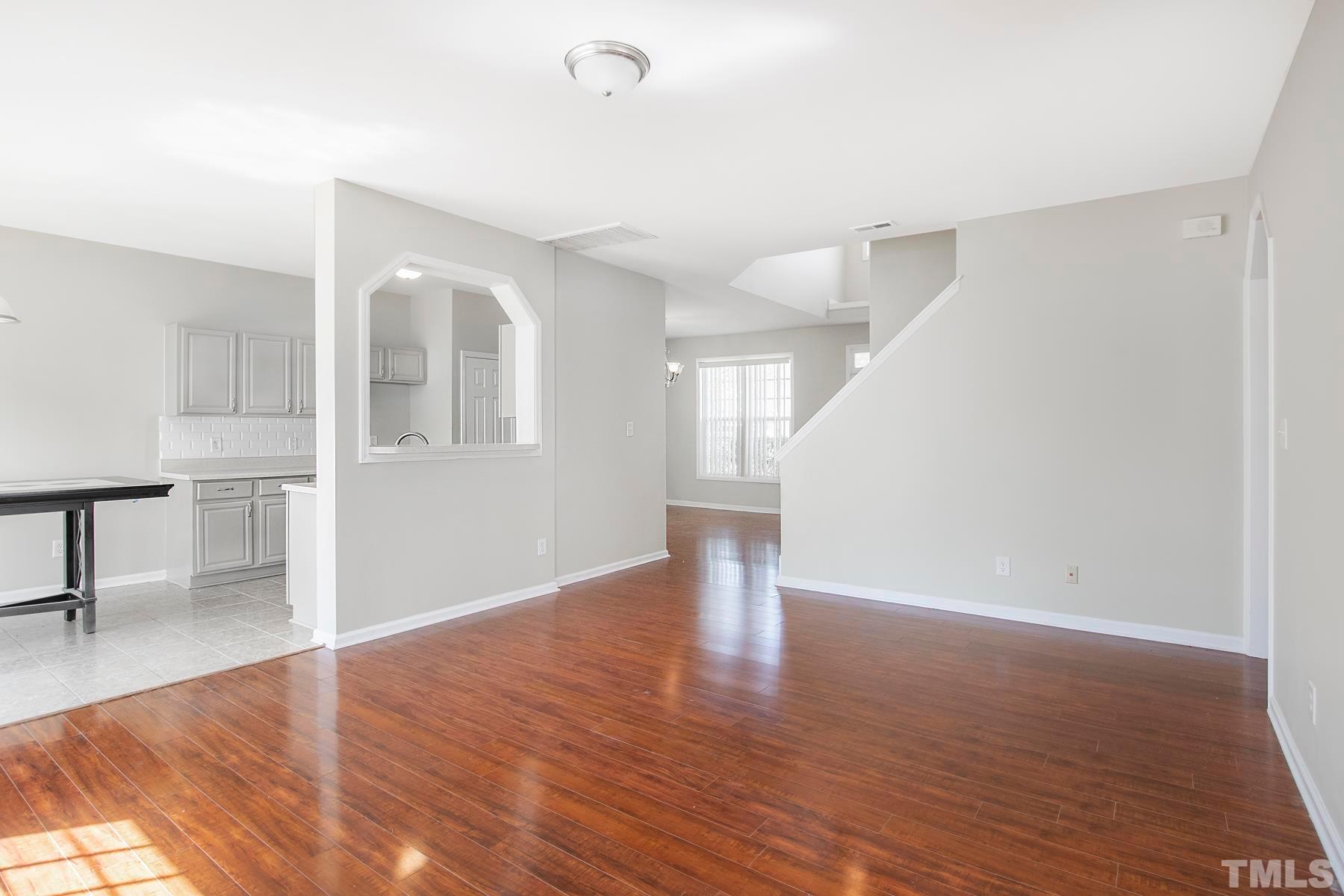 7814 Braefield Drive Raleigh, NC 27616 - Photo 13 of 29 a view of empty room with wooden floor