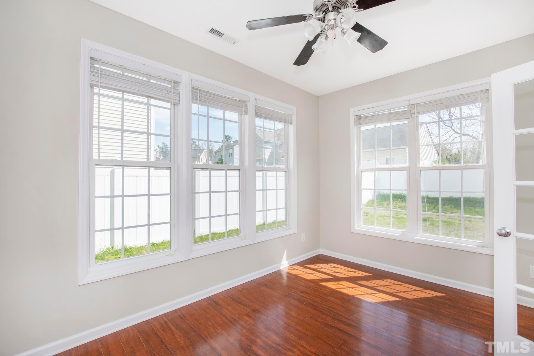 7814 Braefield Drive Raleigh, NC 27616 - Photo 16 of 29 a view of an empty room with wooden floor and a window