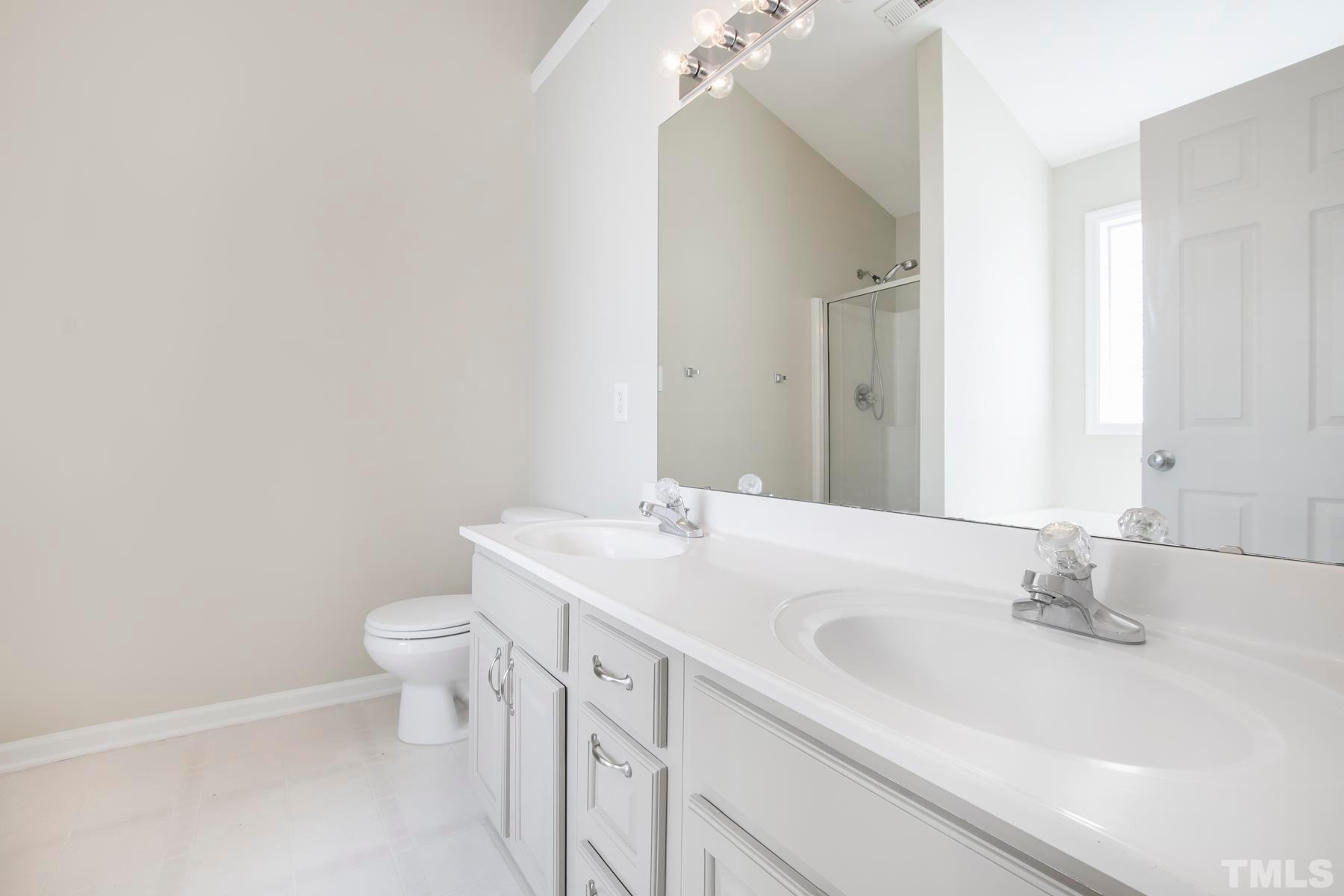 7814 Braefield Drive Raleigh, NC 27616 - Photo 18 of 29 a bathroom with a sink and a toilet