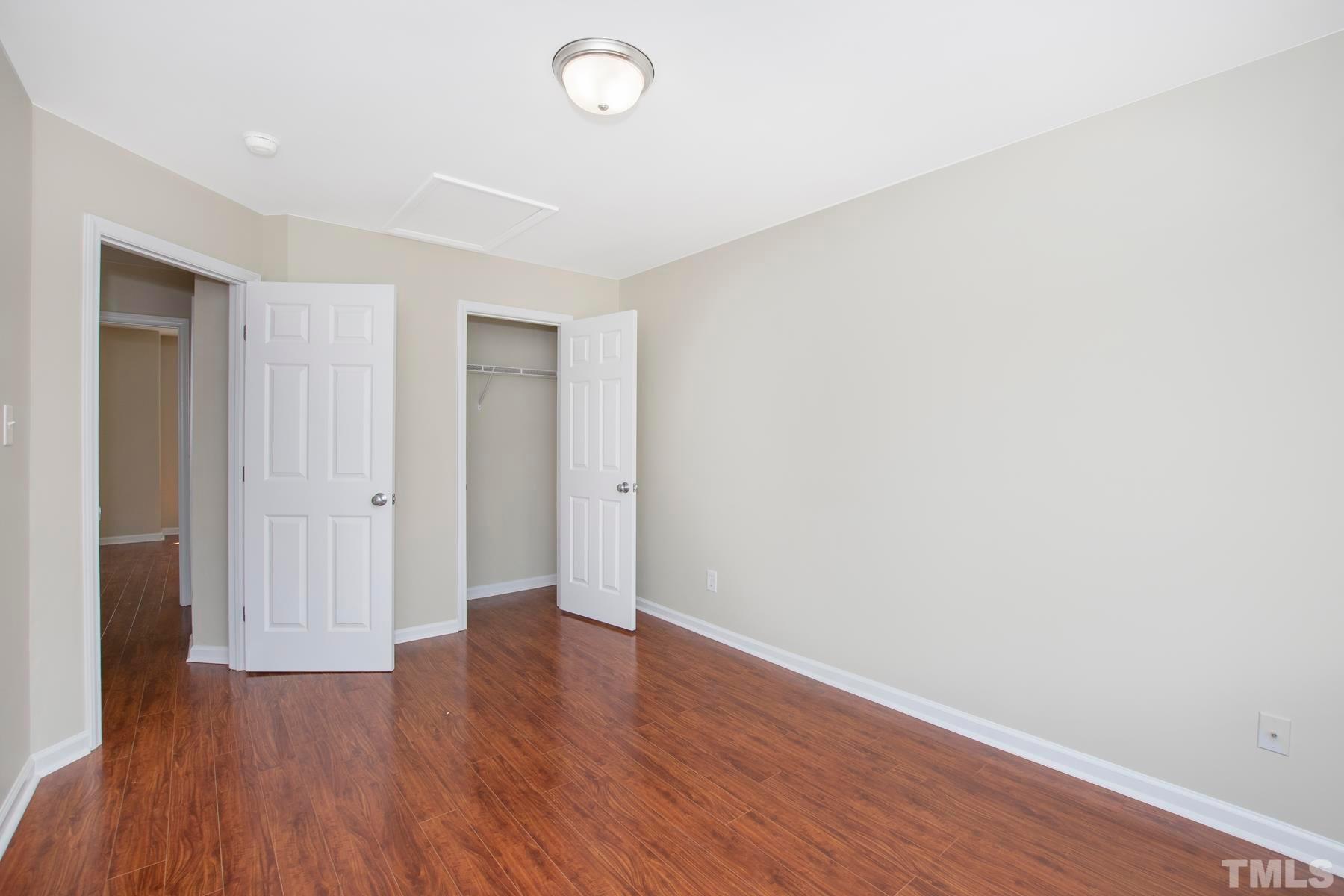 7814 Braefield Drive Raleigh, NC 27616 - Photo 20 of 29 a view of an empty room with wooden floor