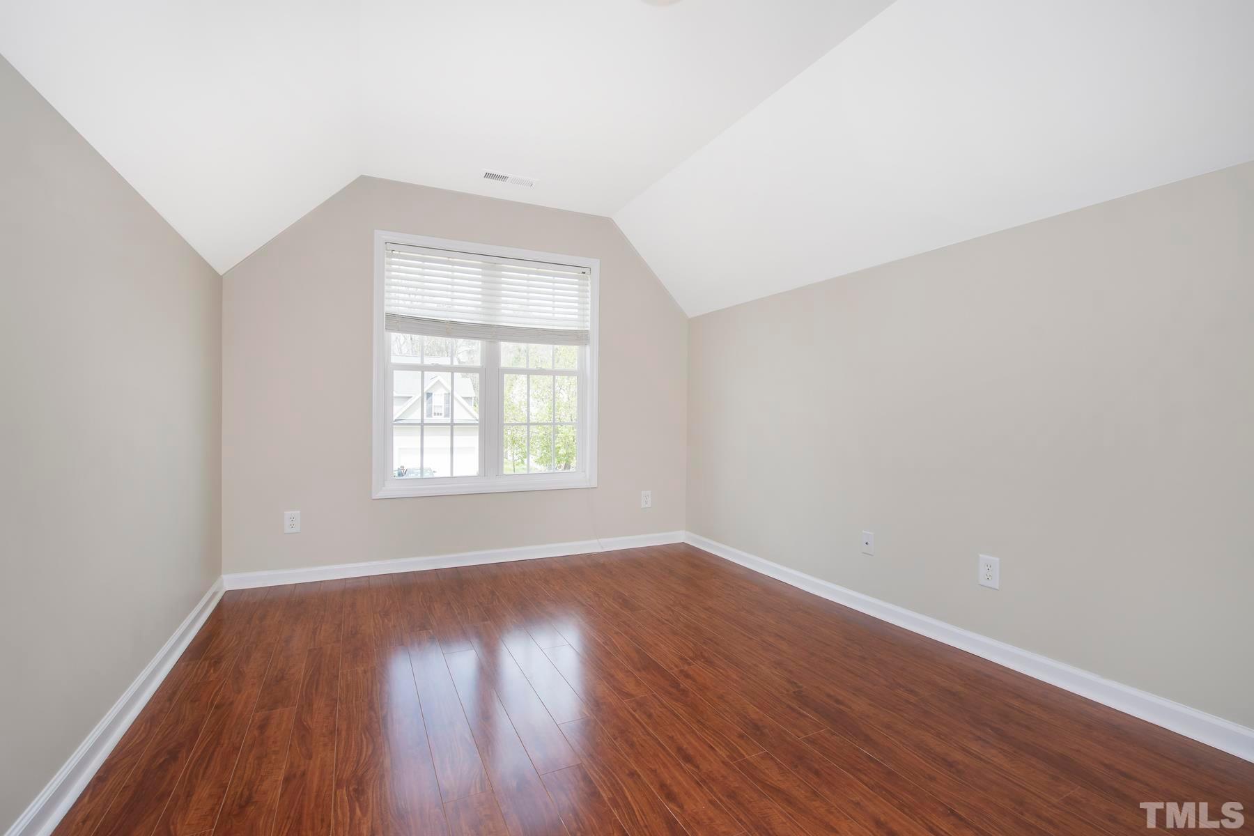 7814 Braefield Drive Raleigh, NC 27616 - Photo 21 of 29 an empty room with wooden floor and windows
