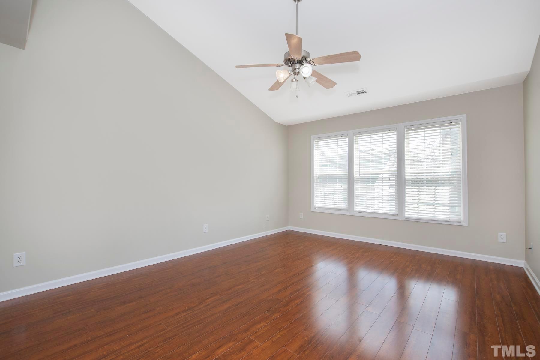 7814 Braefield Drive Raleigh, NC 27616 - Photo 22 of 29 a view of an empty room with wooden floor and a window