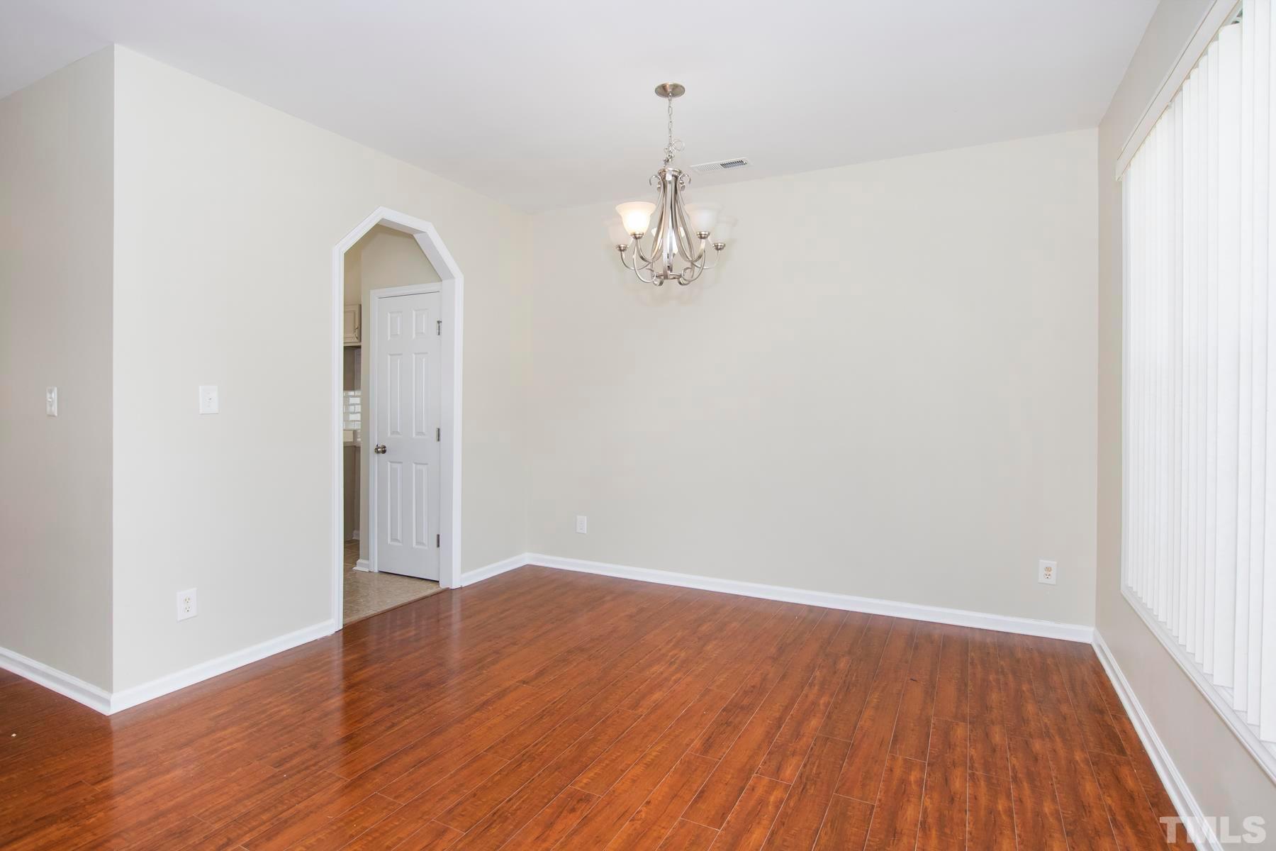 7814 Braefield Drive Raleigh, NC 27616 - Photo 23 of 29 wooden floor in an empty room with a window