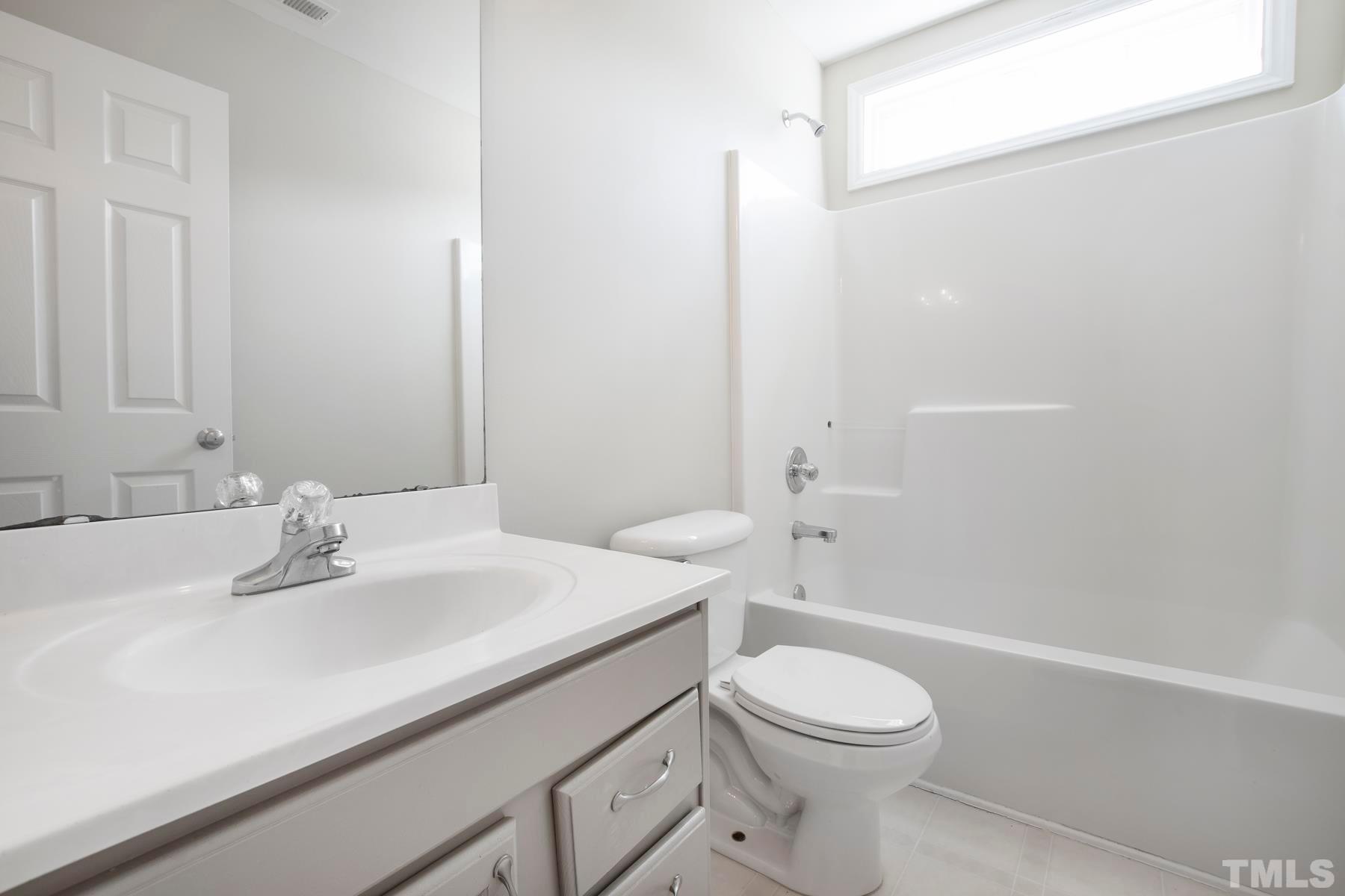 7814 Braefield Drive Raleigh, NC 27616 - Photo 24 of 29 a bathroom with a sink a toilet and shower