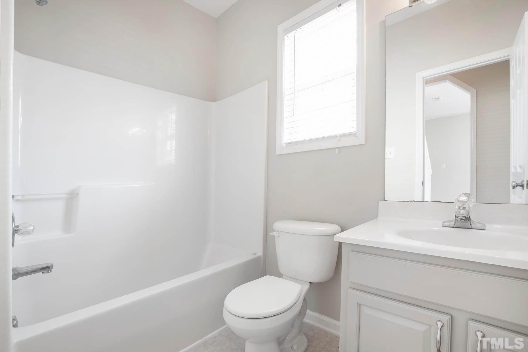 7814 Braefield Drive Raleigh, NC 27616 - Photo 26 of 29 a bathroom with a sink a toilet and a bathtub