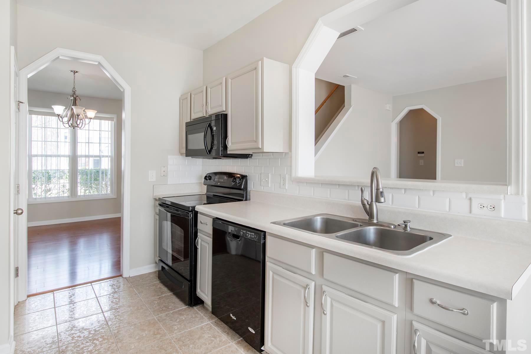 7814 Braefield Drive Raleigh, NC 27616 - Photo 6 of 29 a kitchen with stainless steel appliances granite countertop a sink and a stove
