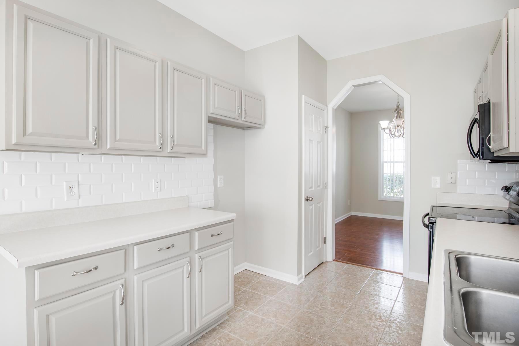 7814 Braefield Drive Raleigh, NC 27616 - Photo 7 of 29 a kitchen with white cabinets