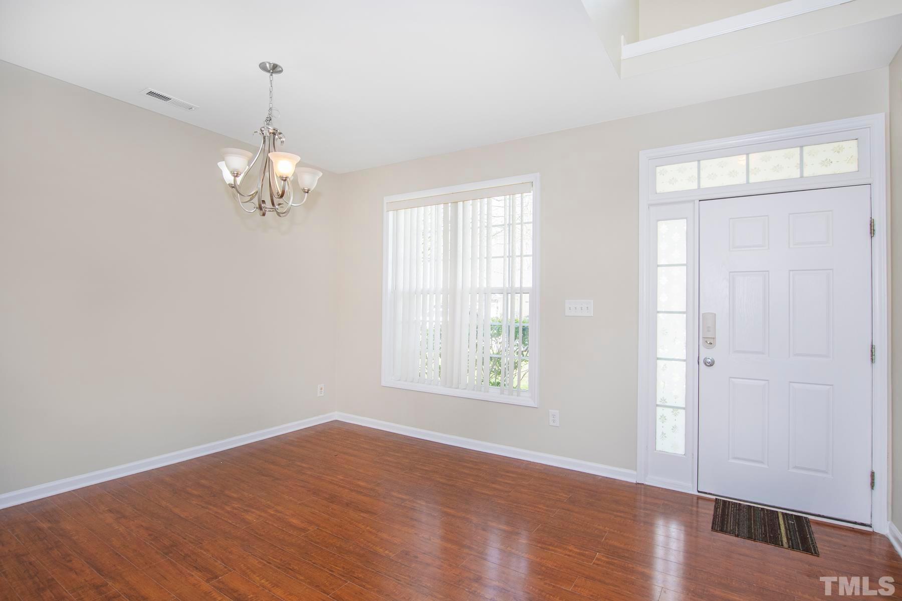 7814 Braefield Drive Raleigh, NC 27616 - Photo 10 of 29 wooden floor in an empty room with a window