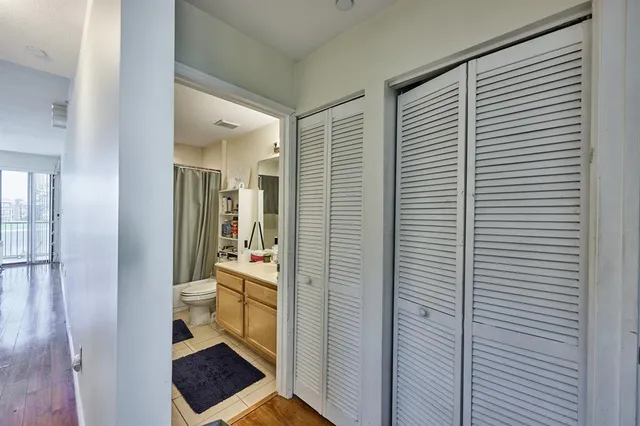 a bathroom with a toilet and a shower