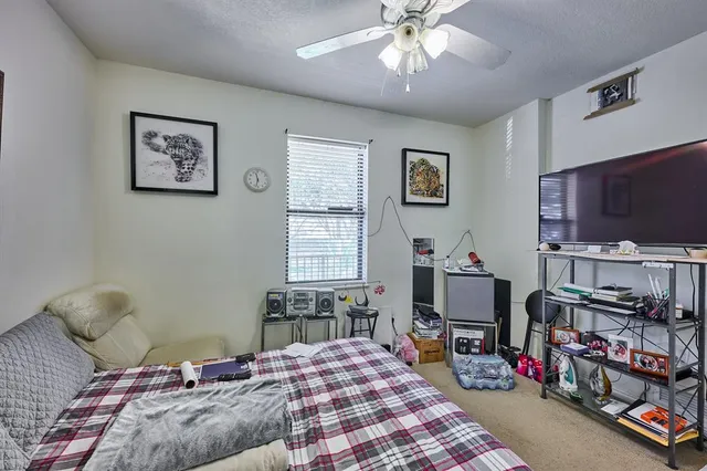 a bedroom with furniture and a flat screen tv
