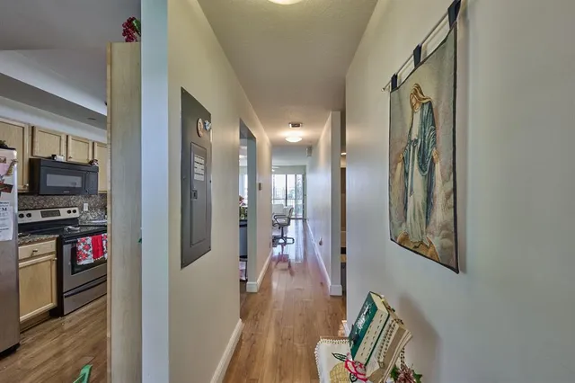a view of a hallway view with wooden floor and staircase