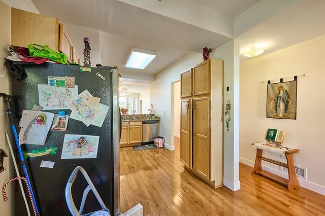 a view of a hallway with workspace and a window