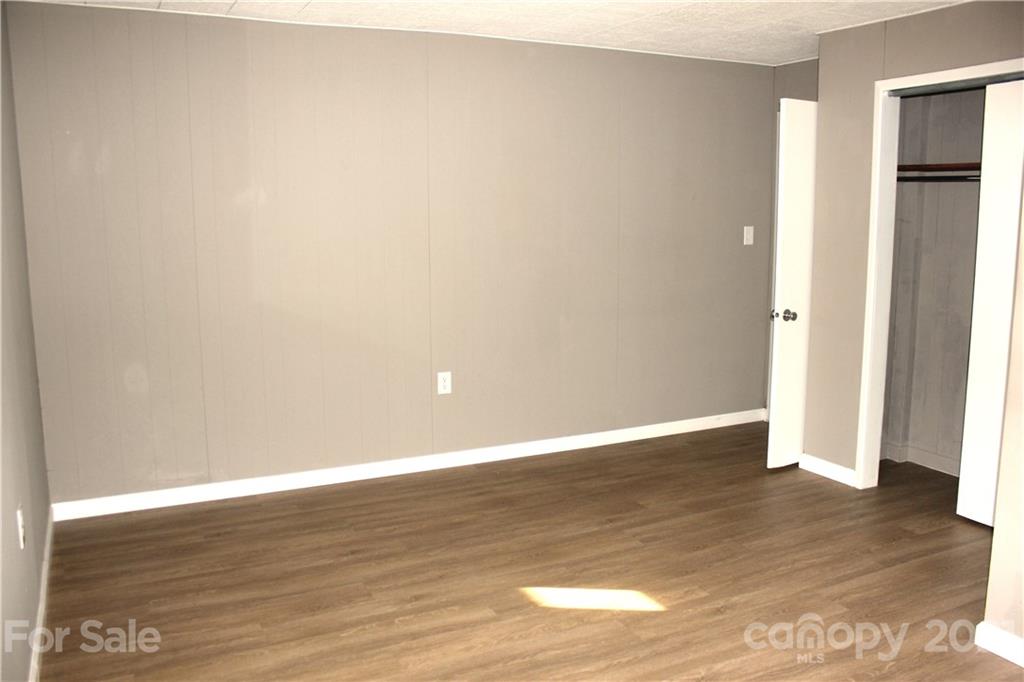 76 Hummingbird Ridge Canton, NC 28716 - Photo 22 of 43 a view of an empty room with wooden floor and closet