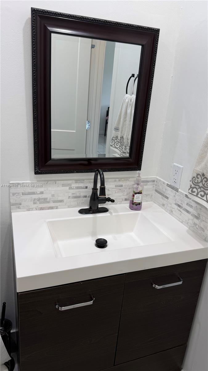 13671 Southwest 62nd Street, Unit 2011 Miami, FL 33183 - Photo 13 of 20 a bathroom with a sink and a mirror