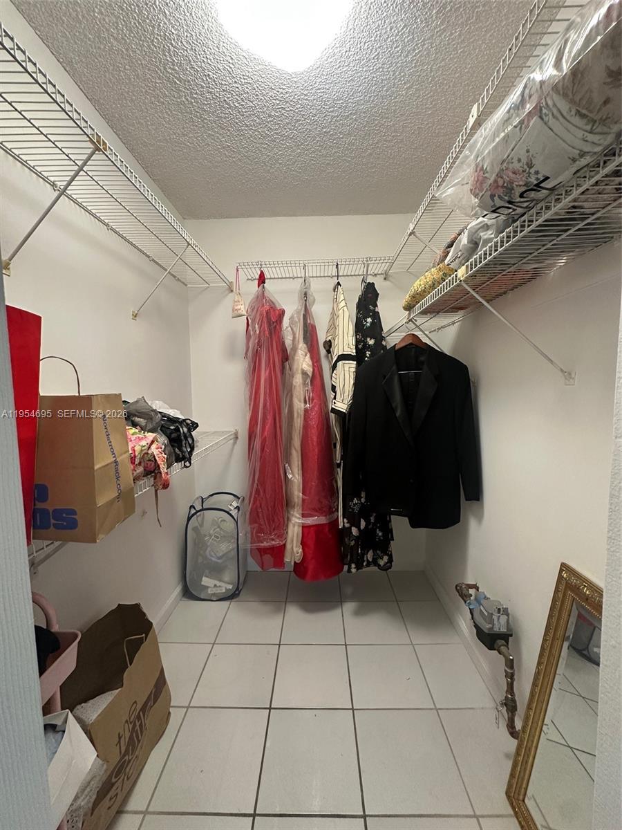 13671 Southwest 62nd Street, Unit 2011 Miami, FL 33183 - Photo 16 of 24 a view of walk in closet with clothes