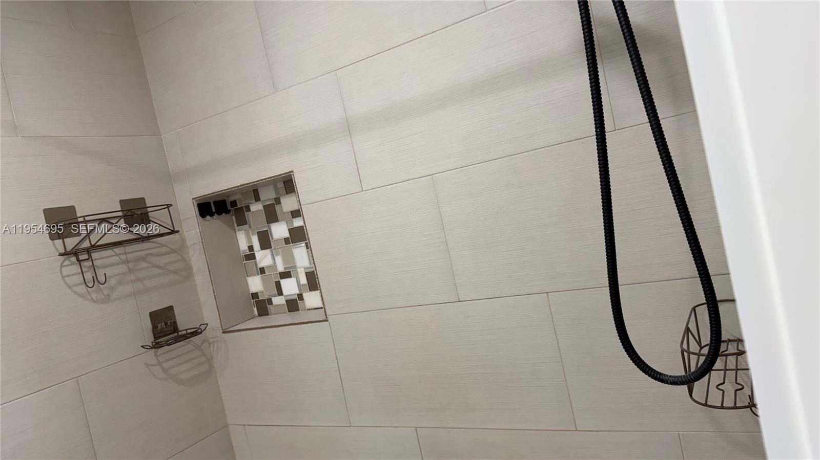 13671 Southwest 62nd Street, Unit 2011 Miami, FL 33183 - Photo 16 of 20 a bathroom with a shower and mirror