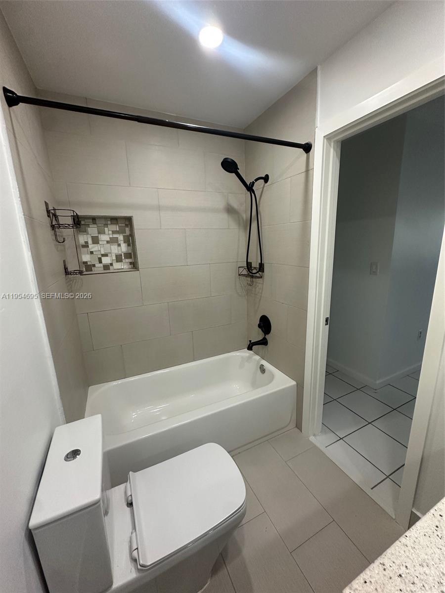 13671 Southwest 62nd Street, Unit 2011 Miami, FL 33183 - Photo 18 of 24 a bathroom with a tub a toilet and a shower