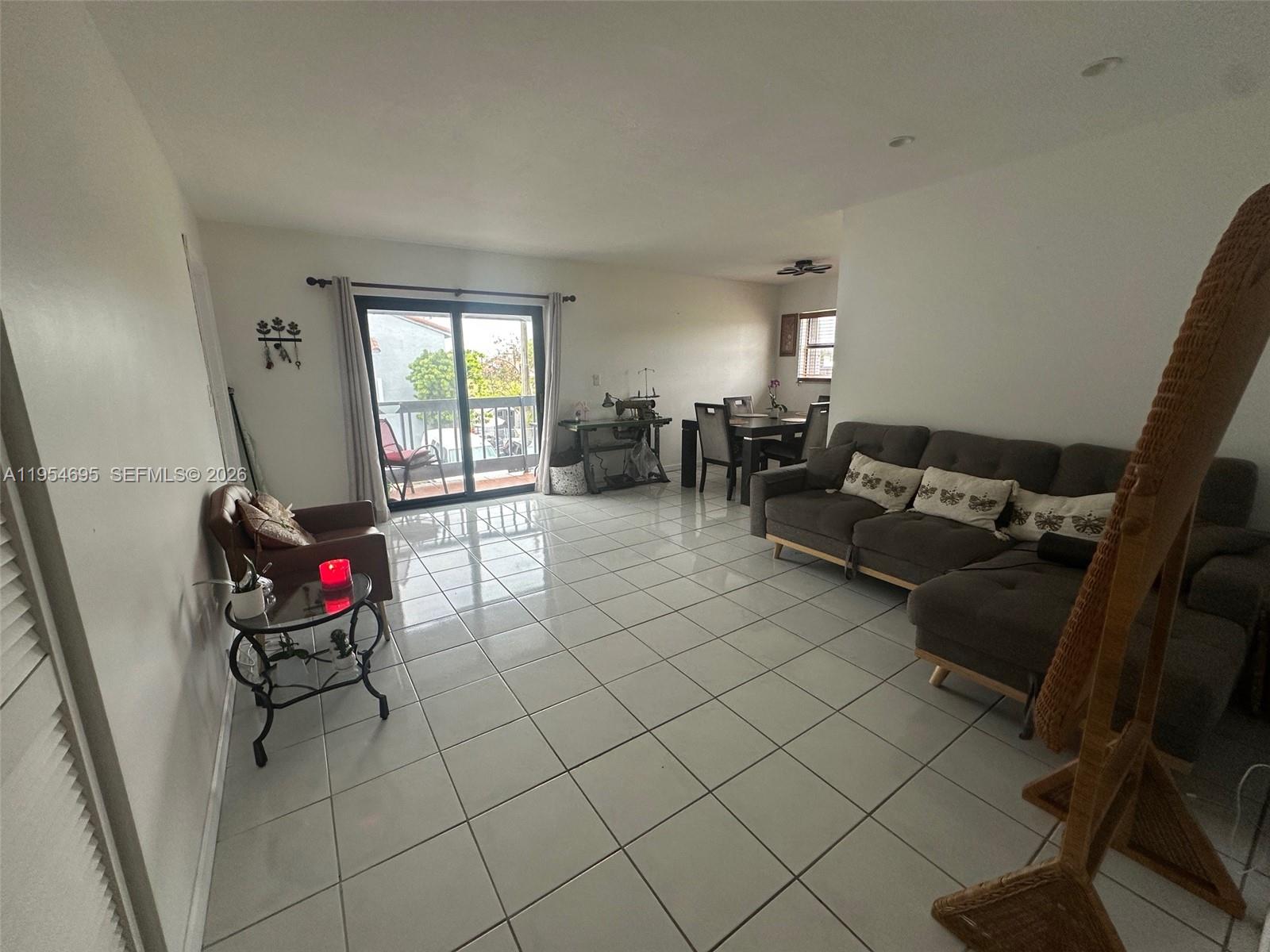 13671 Southwest 62nd Street, Unit 2011 Miami, FL 33183 - Photo 20 of 24 a living room with furniture and a flat screen tv