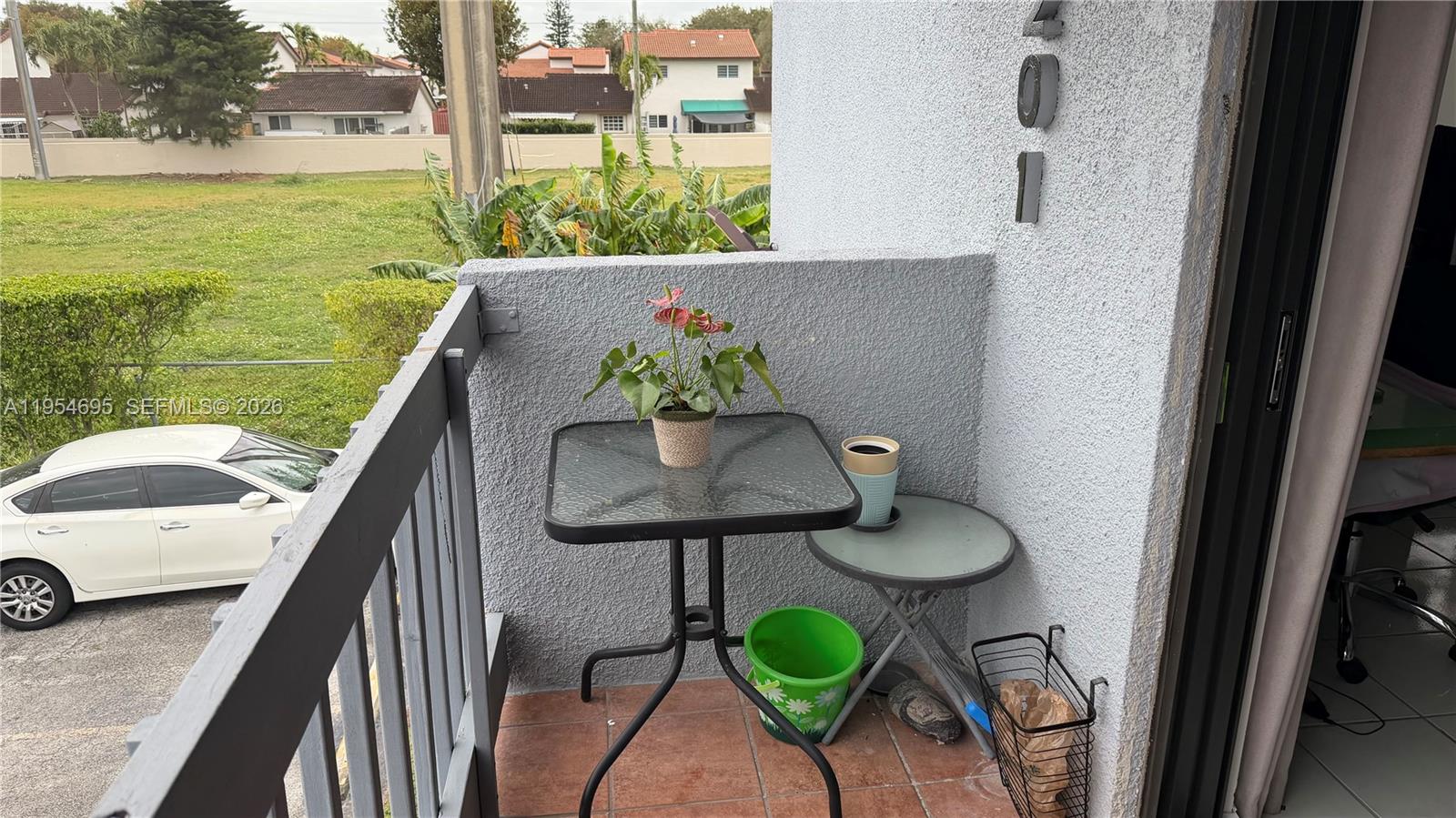 13671 Southwest 62nd Street, Unit 2011 Miami, FL 33183 - Photo 24 of 24 a balcony with table and chairs