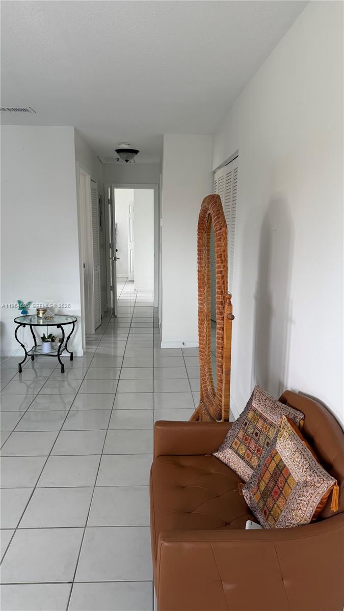 13671 Southwest 62nd Street, Unit 2011 Miami, FL 33183 - Photo 5 of 20 a bedroom with a bed and a mirror